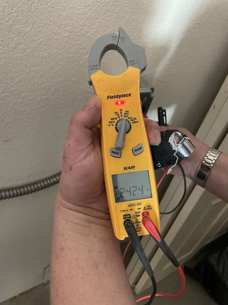 Voltage testing with clamp meter during Recessed Lighting Installation in Dunwoody